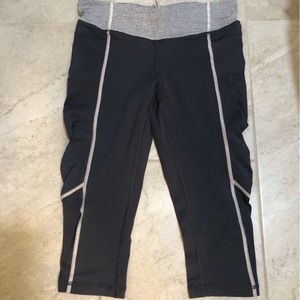 Lululemon grey and light pink running capris, fun rousing on the side, size 6.